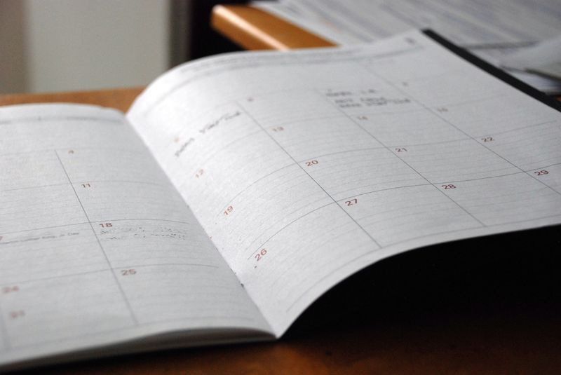 Wristwatch on a calendar representing time tracking and scheduling